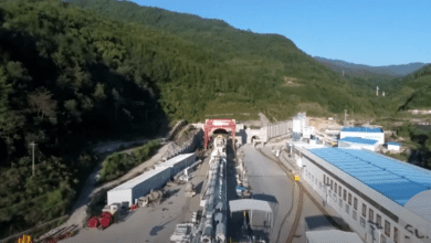 a large tunnel with a large tunnel in the middle of a mountain